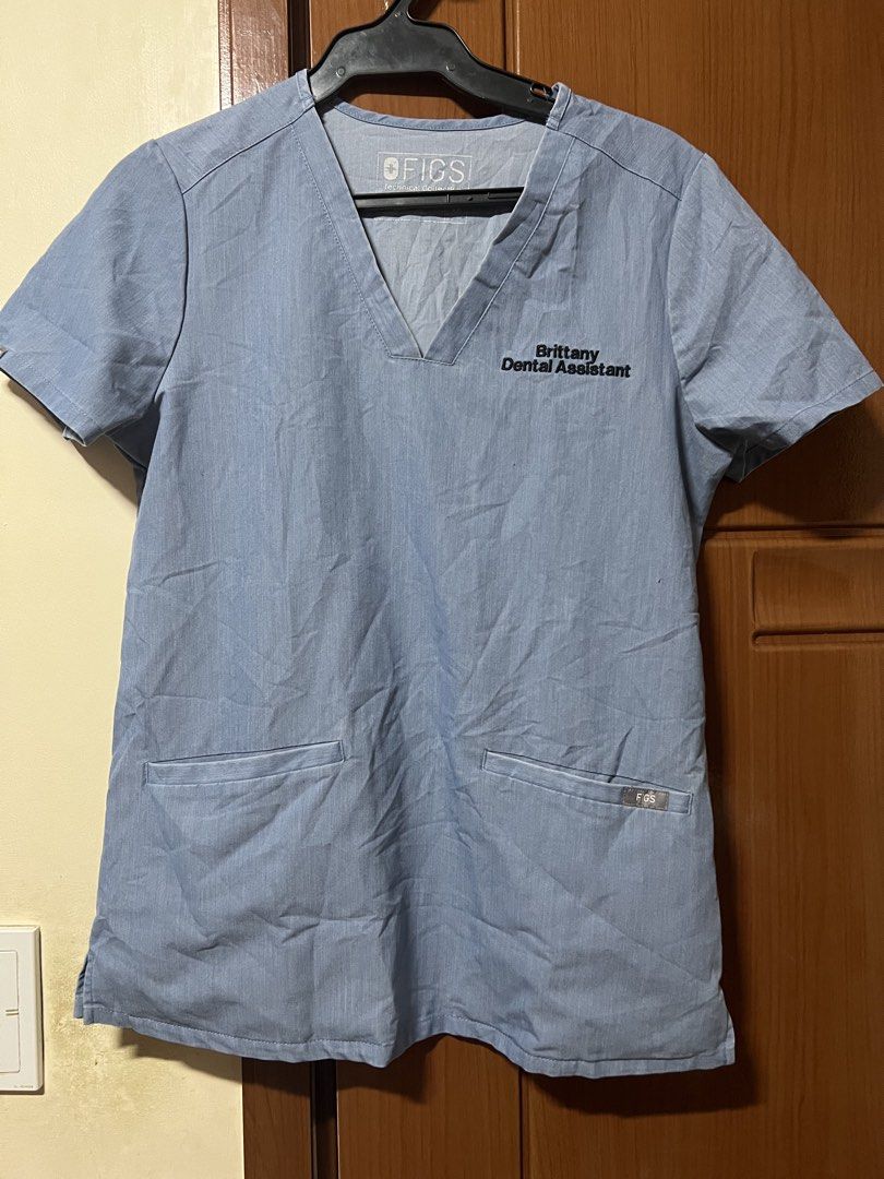 FIGS Blue Scrub Top - Brittany Dental Assistant (Category: Others Tops) located in Baguio. Submitted by kquizon1037 (Listing ID 1459009874, Image 1). Description: - Light blue FIGS scrub top - **FLAW** ‘Brittany Dental Assistant' embroidered on chest - Two front pockets - Short sleeves - Comfortable material for work - Perfect for dental professionals or vet techs.