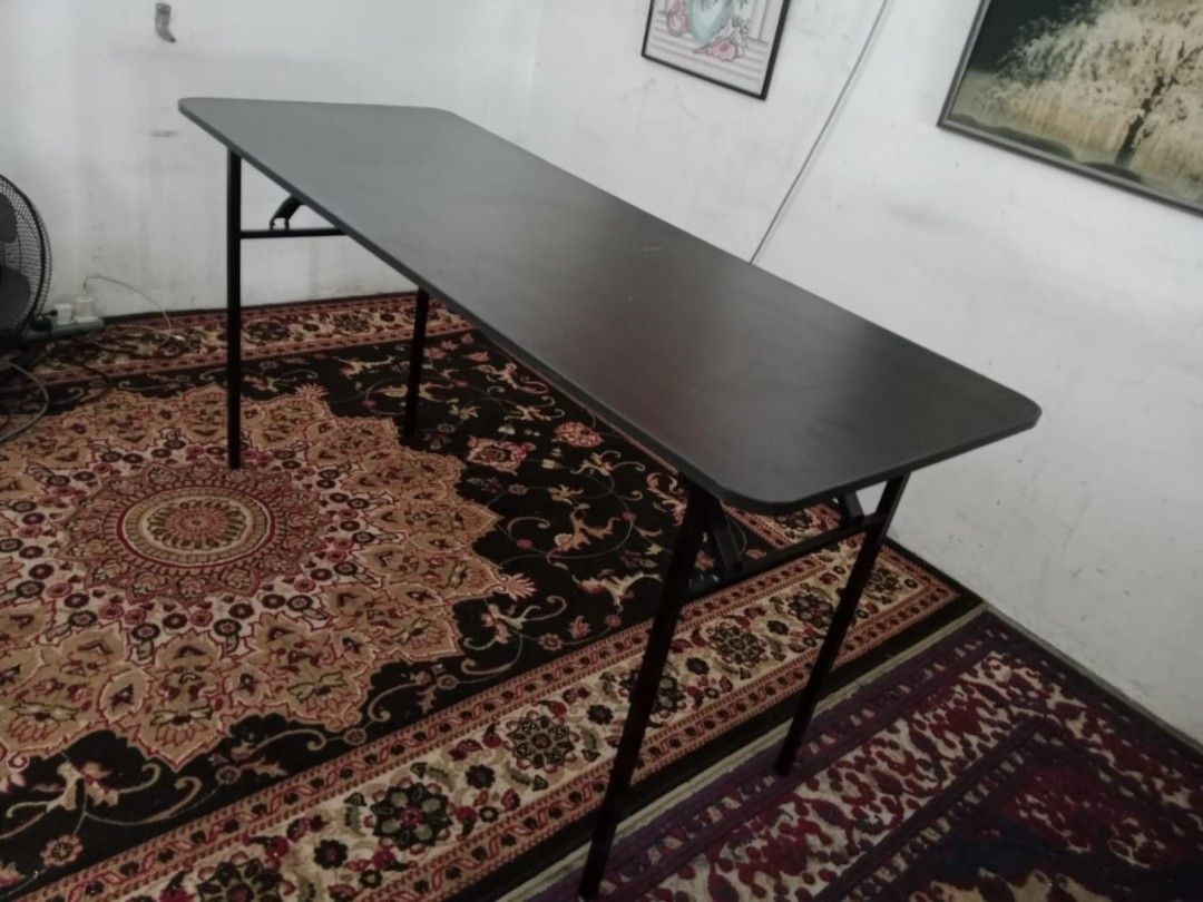 Foldable Dark Brown Rectangular Table (Category: Tables & Sets) located in Shah Alam. Submitted by _naufalperabutterpakai (Listing ID 1458963710, Image 2). Description: - Dark brown foldable table - Rectangular top with rounded corners - Legs fold up for easy storage and transport - Ideal for events, study, or temporary workspace - Sturdy construction - NAUFAL PERABUT TERPAKAI 52A JALAN MUSYTARI AN U5/AN TAMAN SUBANG PELANGI SEKSYEN U5 40150 SHAH