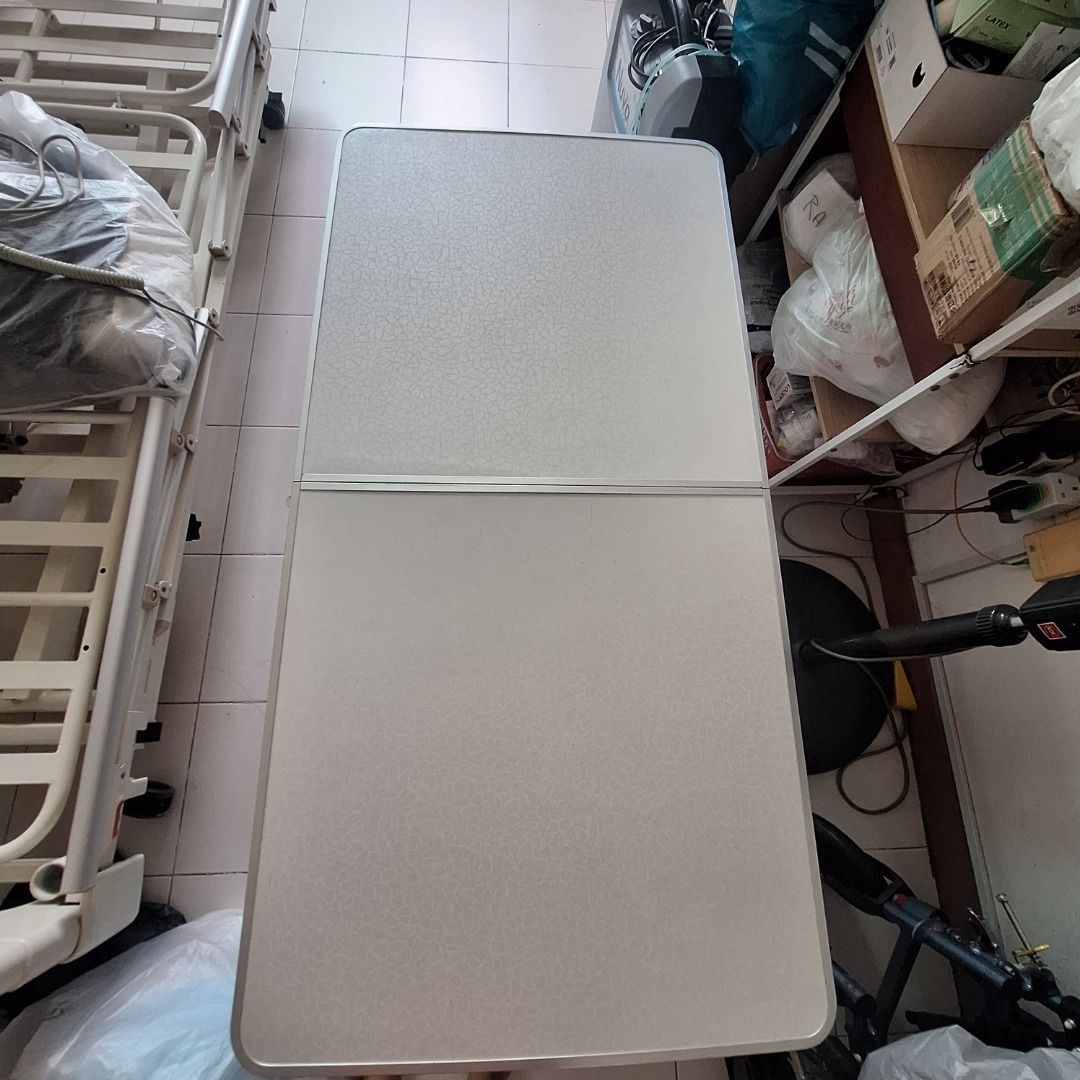 Foldable Table (Category: Tables & Sets) located in Singapore. Submitted by jessicaleekoksim (Listing ID 1458931002, Image 2). Description: - Foldable table - White patterned top - Silver aluminum frame - Folds in half for easy storage and transport - Perfect for small spaces, picnics, parties, or as a temporary desk.