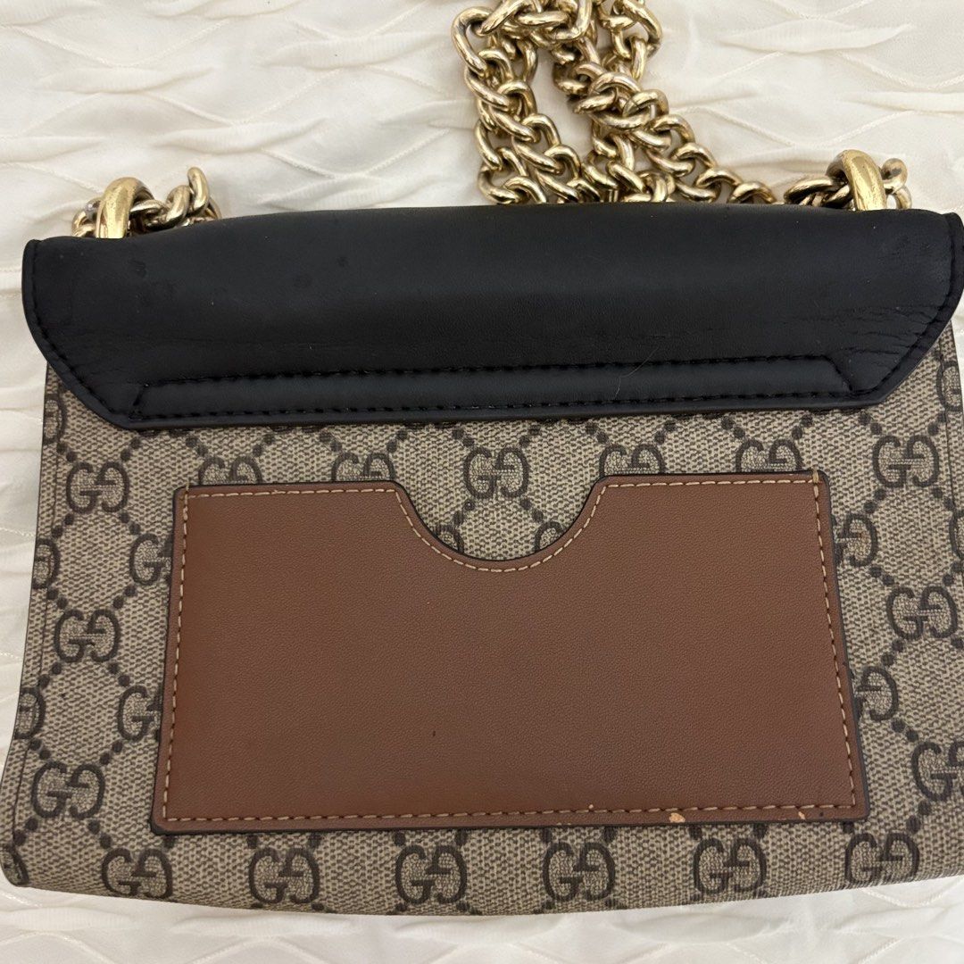[FREE SF] Gucci Padlock small shoulder bag (Category: Luxury Bags & Wallets) located in Dagupan City. Submitted by sol.bi (Listing ID 1459061168, Image 3). Description: - Authentic Gucci shoulder bag - Classic GG Supreme canvas with black leather trim - Gold-tone hardware and chain strap - Interior leather tag with Gucci logo and 'made in italy' - Serial number: 409487 0808 - Ideal for everyday use.