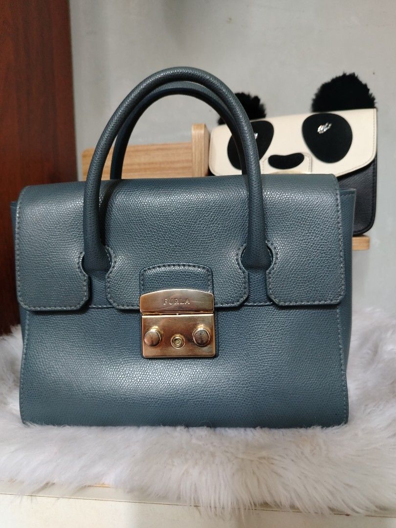 Furla Metropolis Satchel Bag (Category: Luxury Bags & Wallets) located in Lucena. Submitted by gracious_chin0436 (Listing ID 1458905619, Image 1). Description: - Signature gold turn-lock closure - Structured, elegant shape - Comfortable top handles for carrying - Versatile: perfect for daily use or special event - Interior is clean and well-maintained.