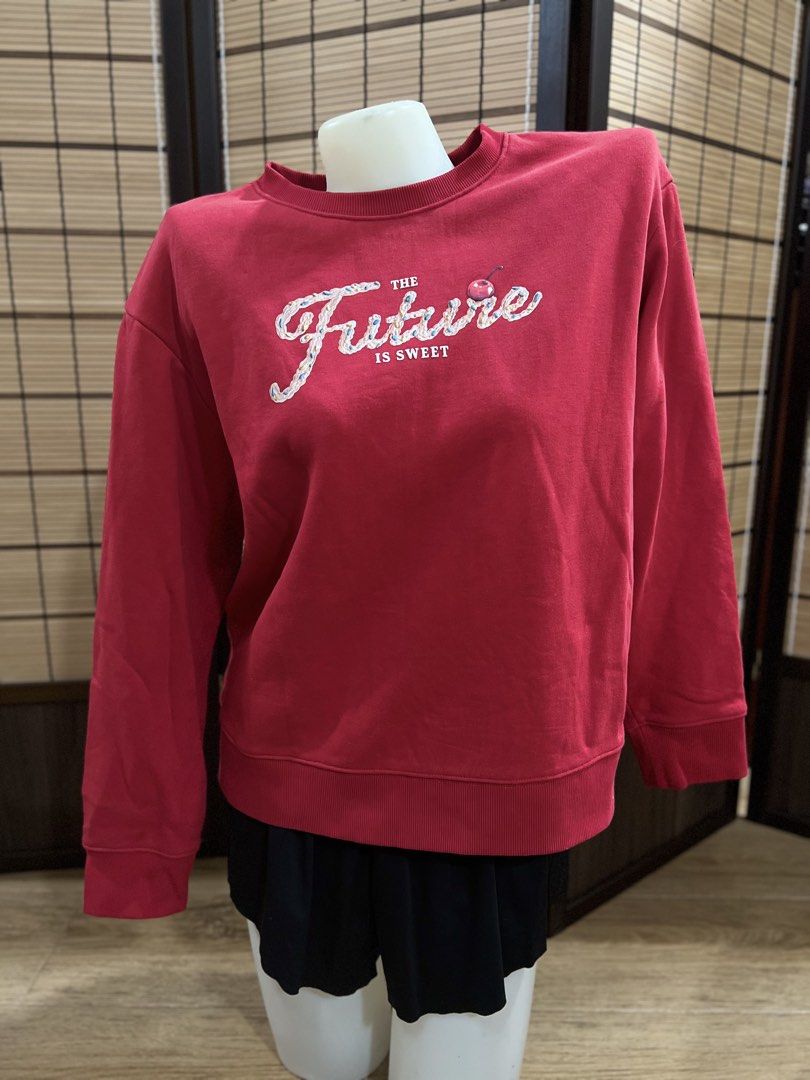 Giordano Red "The Future Is Sweet" Sweatshirt Size M (Category: Coats, Jackets and Outerwear) located in Subic. Submitted by xzikyra (Listing ID 1458905397, Image 1). Description: - Giordano Red Sweatshirt - "The Future Is Sweet" graphic on front - Ribbed cuffs and hem - Size: Medium (M) - Ideal for casual wear.