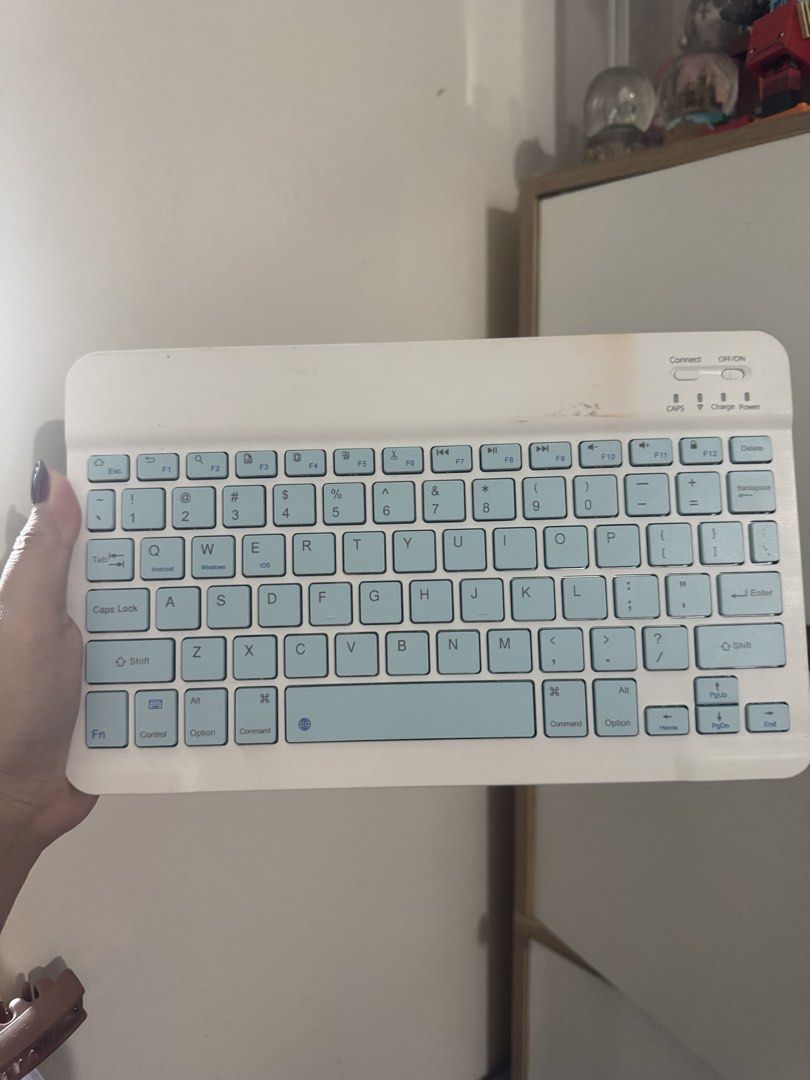 GOOJODOQ Bluetooth Keyboard White Light Blue Keys (Category: Computer Keyboard) located in Manila. Submitted by redvelvetcheesecake13 (Listing ID 1458907061, Image 1). Description: - Has a stain at the top part - Works perfectly - Features indicator lights for CAPS Lock, Charging, and Power status - Compatible with Android, iOS, and Windows devices .