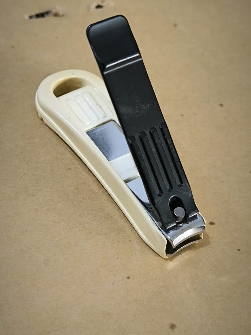 Green Bell Nail Clipper with Protective Catcher Guard (Category: Hands & Nails) located in Angeles City. Submitted by yellowbrickstore (Listing ID 1458959956, Image 1). Description: - Genuine Green Bell nail clippers made in Japan - Includes a beige protective case with hanging loop - Durable metal clippers with a comfortable black handle and red accent - Perfect for everyday personal grooming - Cleaned and ready for immediate use.