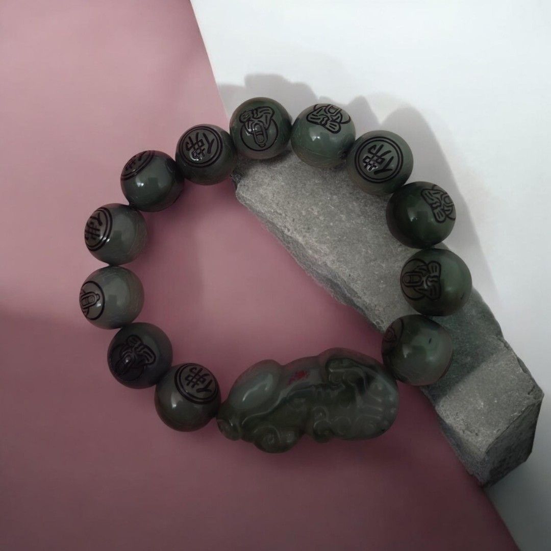 Green Jadeite Bracelet with Carved Charm (Category: Bracelets) located in Antipolo. Submitted by goodsinger (Listing ID 1458969183, Image 2). Description: - Genuine green jadeite beads - Unique carved charm (mythical creature/animal) - Natural sheen and varied green hues - Comfortable elastic band for easy wear - Perfect addition to any jewelry collection.