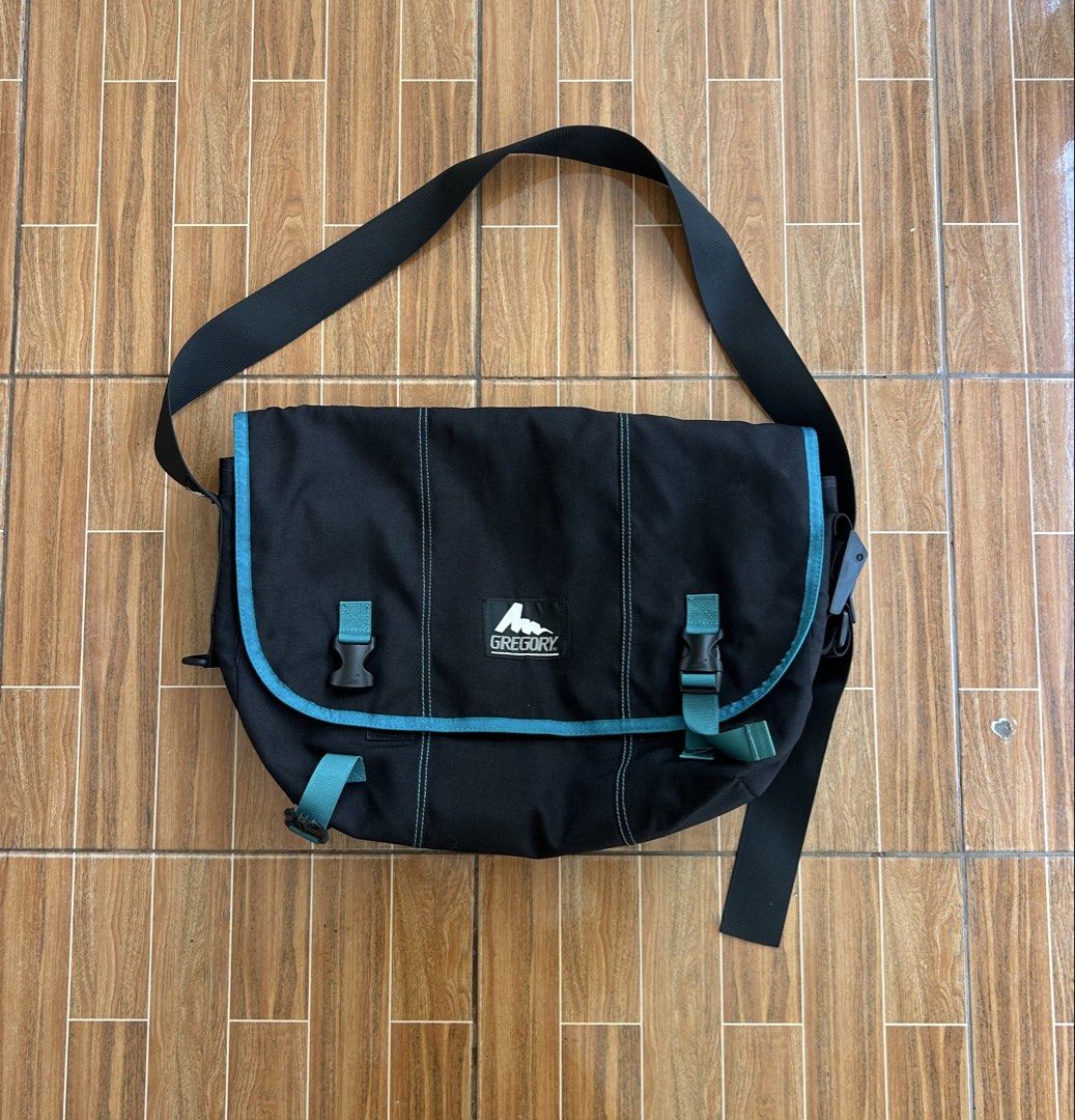 Gregory Messenger Bag Black Teal Accents (Category: Sling Bags) located in Cagayan de Oro. Submitted by aljay02 (Listing ID 1458953035, Image 2). Description: - Brand: Gregory - Color: Black with teal accents - Closure: Two buckle closures on front flap - Strap: Adjustable shoulder strap - Dimensions: Approximately 19 inches wide x 14 inches tall - Ideal for: Everyday use or travel.