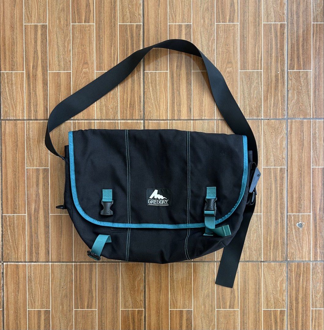Gregory Messenger Bag Black Teal Accents (Category: Sling Bags) located in Cagayan de Oro. Submitted by aljay02 (Listing ID 1458953035, Image 1). Description: - Brand: Gregory - Color: Black with teal accents - Closure: Two buckle closures on front flap - Strap: Adjustable shoulder strap - Dimensions: Approximately 19 inches wide x 14 inches tall - Ideal for: Everyday use or travel.
