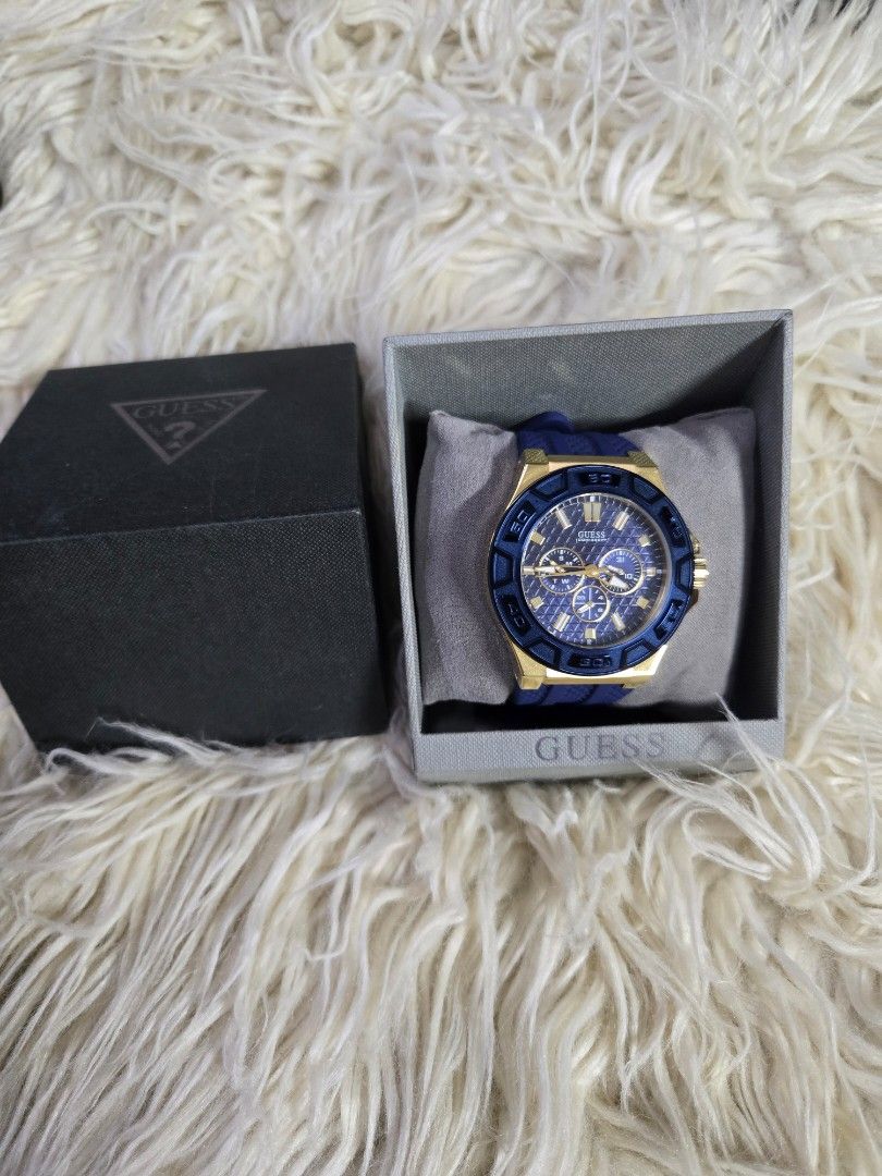 Guess force men's multifunction quartz watch (Category: Men's Watches) located in Quezon City. Submitted by bags4ever (Listing ID 1458959251, Image 2). Description: Key Features & Specifications Design: Bold sporty aesthetic combining a yellow gold-tone stainless steel case with a fixed textured blue bezel. Dial: Dark blue textured dial featuring three multi-function subdials that track the day of the week, date, and 24-hour time. Strap: Integrat