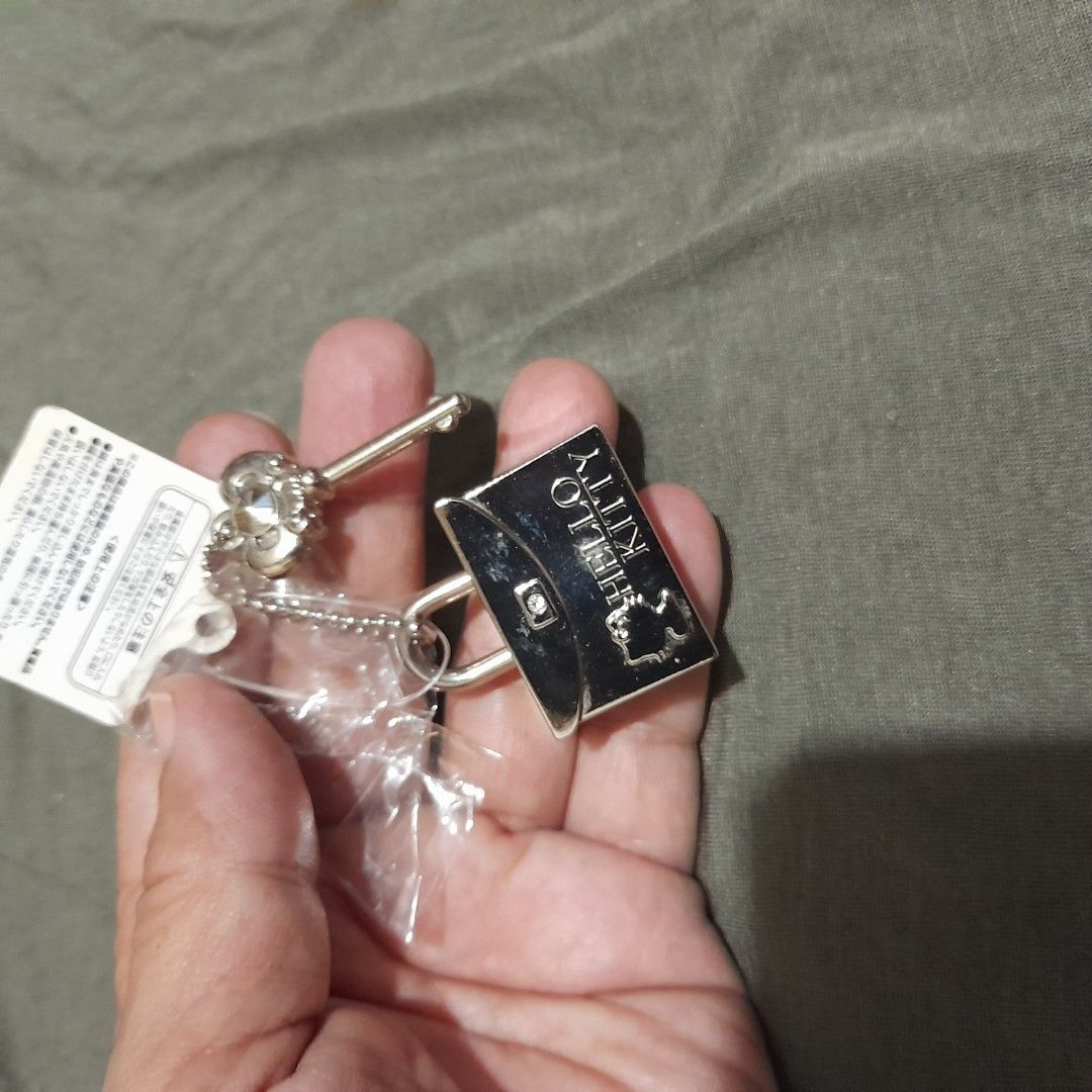 Hello Kitty Lock and Key Keychain (Category: Character Goods) located in Bocaue. Submitted by marajapansurplus (Listing ID 1458955808, Image 1). Description: - Adorable Kitty lock and key design - Silver tone metal finish - Brand new with original tags - Never used, still in packaging - Ideal for decorating bags or as a collectible item.