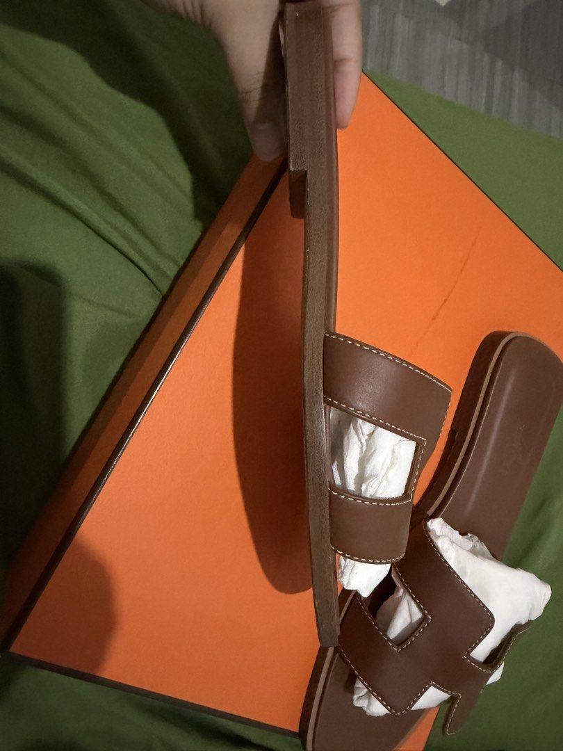 Hermes Oran Slippers - Authentic (Category: Flats & Sandals) located in Manila. Submitted by thraciecapule (Listing ID 1458917594, Image 3). Description: - Comes with box, dust bag and paper bag - Authentic Hermes H sandals - Color: Brown - Material: Smooth leather - Features neat stitching - Includes original box and paper bag - Versatile for casual or dressed-up looks RFS: got pregnant after buying, feet changed size. .