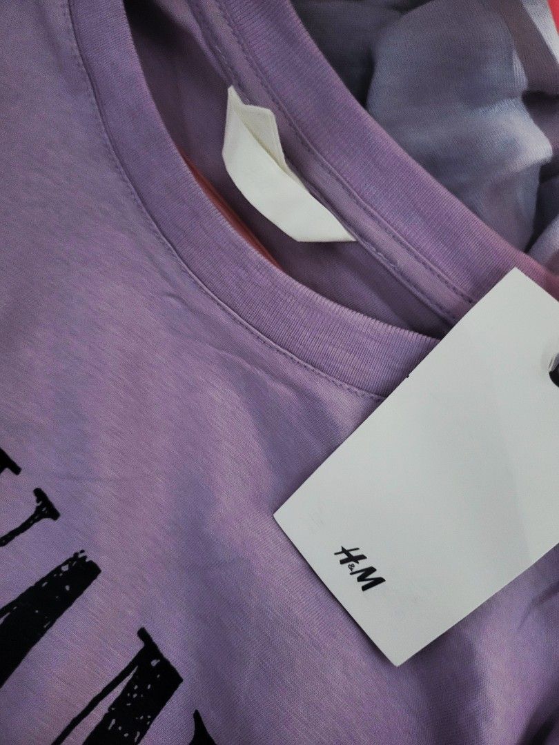 H&M Overruns Nirvana Graphic T-shirt (Category: Shirts) located in Pasig City. Submitted by inigosdreamshop (Listing ID 1459084591, Image 3). Description: - Oversized lilac t-shirt - Features iconic Nirvana angel graphic - Brand: H&M (overruns) - Measurements: 44 inches width, 23 inches length - Comfortable and stylish - Ideal for Nirvana fans.
