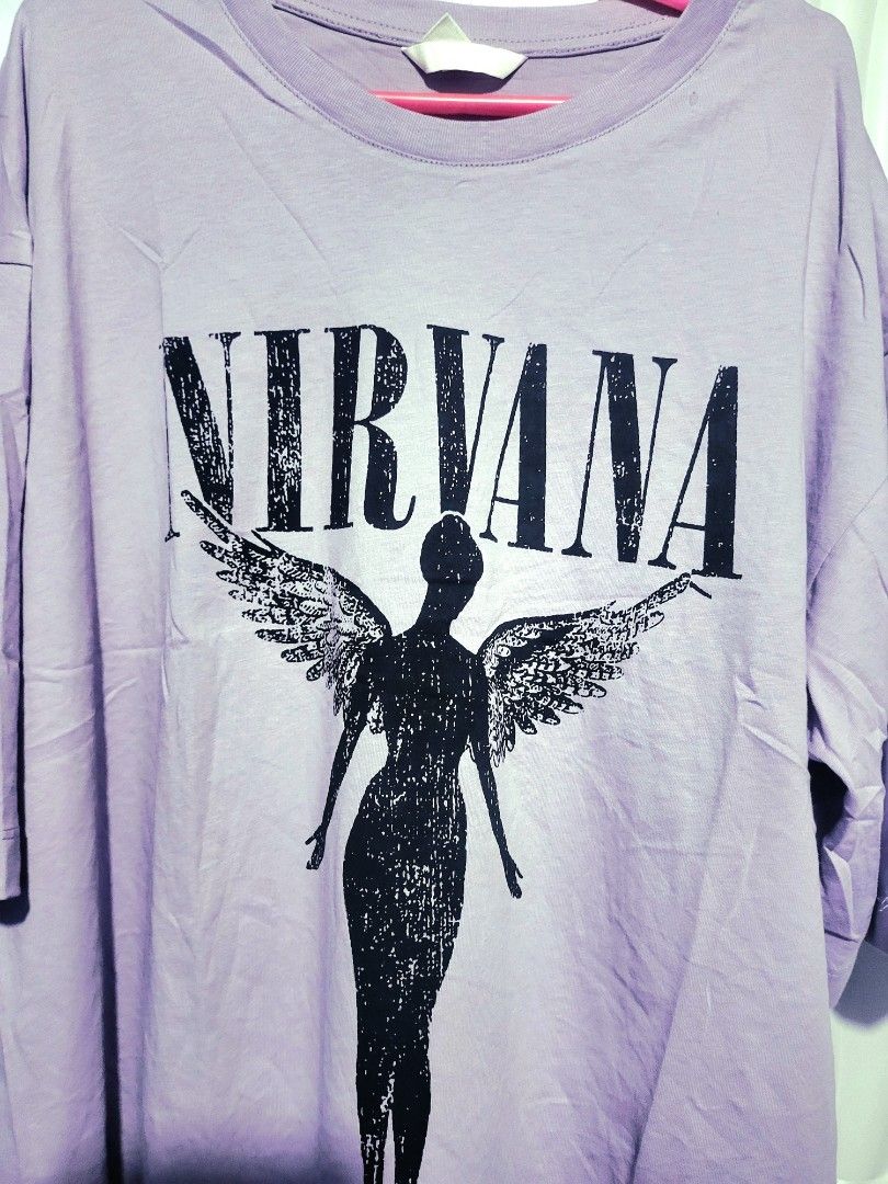H&M Overruns Nirvana Graphic T-shirt (Category: Shirts) located in Pasig City. Submitted by inigosdreamshop (Listing ID 1459084591, Image 2). Description: - Oversized lilac t-shirt - Features iconic Nirvana angel graphic - Brand: H&M (overruns) - Measurements: 44 inches width, 23 inches length - Comfortable and stylish - Ideal for Nirvana fans.
