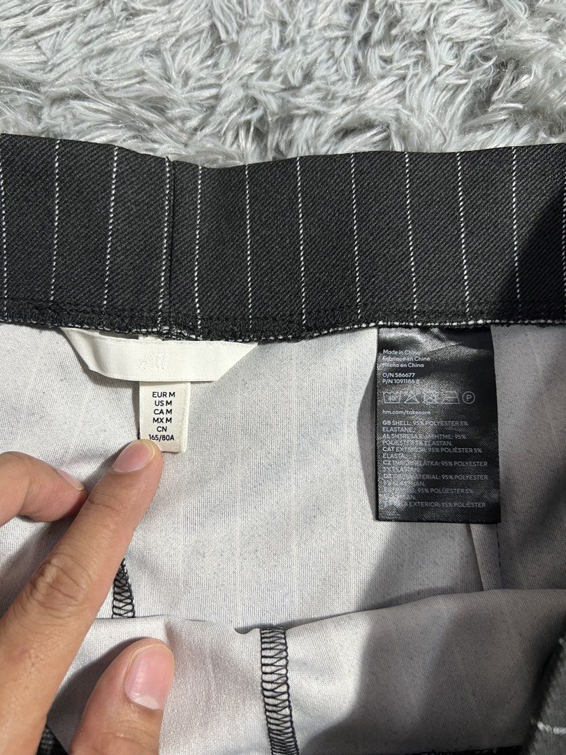 H&M Striped Wide Leg Pants Size M (Category: Trousers) located in Naga. Submitted by eighttttt (Listing ID 1458917228, Image 3). Description: - H&M dark grey pants - White pinstripe detail - Wide leg style - Size: Medium (M) - Versatile: suitable for casual outings or work - Comfortable fit - Size 32.
