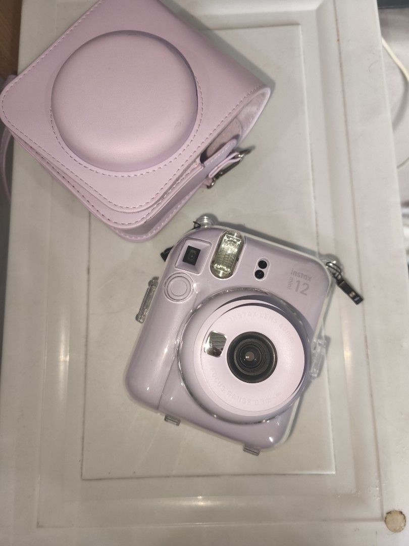 Instax Mini 12 with clear case and leather flannel case bag (Category: Cameras) located in Manila. Submitted by gracey.js (Listing ID 1459004284, Image 3). Description: FOR SALE: Fujifilm Instax Mini 12 📸 Used only 3 times 📸 Excellent condition 📸 Complete and well-maintained Inclusions: ✔ Clear Case ✔ Leather Flannel Bag ✔ FREE 8 pcs Film Payment Method: 💳 GCash or Bank Transfer only 📍 Cainta, Rizal 🚚 Shipping available (buyer shoulders shi