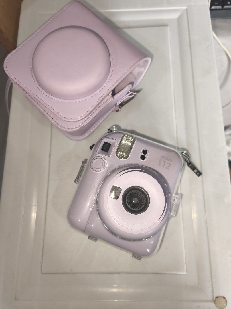 Instax Mini 12 with clear case and leather flannel case bag (Category: Cameras) located in Manila. Submitted by gracey.js (Listing ID 1459004284, Image 2). Description: FOR SALE: Fujifilm Instax Mini 12 📸 Used only 3 times 📸 Excellent condition 📸 Complete and well-maintained Inclusions: ✔ Clear Case ✔ Leather Flannel Bag ✔ FREE 8 pcs Film Payment Method: 💳 GCash or Bank Transfer only 📍 Cainta, Rizal 🚚 Shipping available (buyer shoulders shi