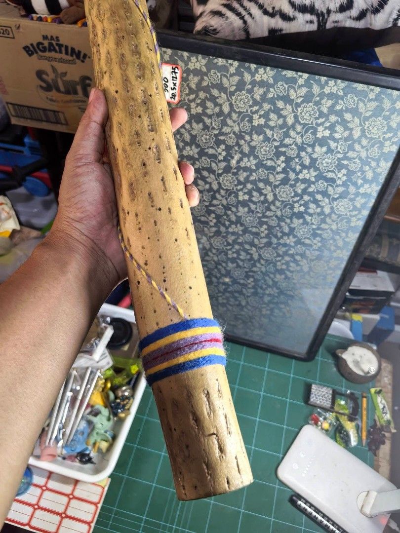 Instrument - Rainstick (Category: Musical Instruments) located in Cebu City. Submitted by dudes_villanueva (Listing ID 1458917803, Image 3). Description: Instrument - Rainstick 📌 A traditional percussion instrument designed to mimic the sound of falling rain. 📌 Material: It seems to be crafted from a dried columnar cactus skeleton, showing a hollow tubular body with natural perforation marks and decorative yarn wrapped around the top and bottom