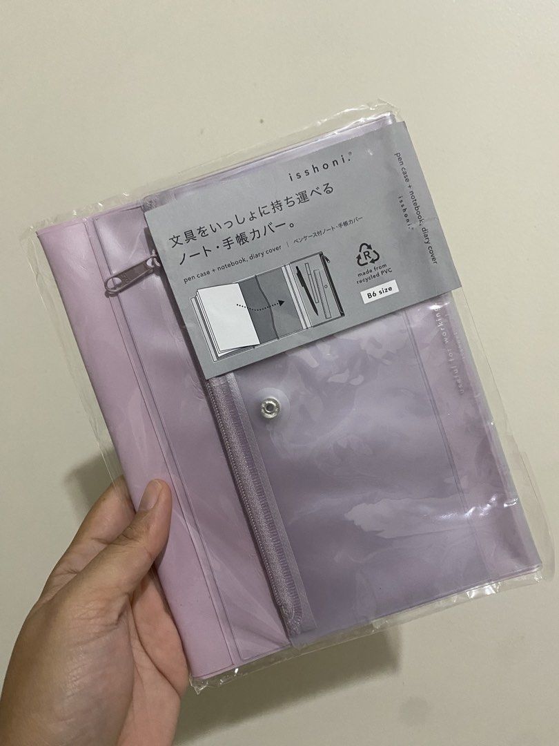 Isshonni B6 Pen Case + Notebook Diary Cover (Category: Stationery & School Supplies) located in Pasig City. Submitted by k0pimonster (Listing ID 1459017719, Image 1). Description: - Isshonni B6 size pen case and notebook diary cover - Made from durable recycled PVC - Features a secure zipper closure - Includes a convenient snap button pocket - Soft lavender/pink color - Ideal for organizing pens and notebooks together.