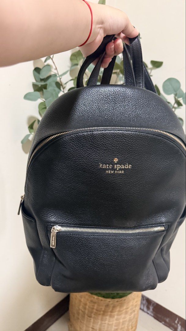 Kate Spade New York Black Leather Backpack (Category: Backpacks) located in Batangas. Submitted by etc.byflc (Listing ID 1458979078, Image 1). Description: 📍 Batangas 📌 Payment first, no COD 🛵🚚 Shipping via J&T or LBC 📩 for inquiries -Authentic, personal preloved - Classic black pebbled leather backpack from Kate Spade New York. - Elegant gold-tone hardware. - Multiple zip pockets for secure storage and organization. - Branded interior linin