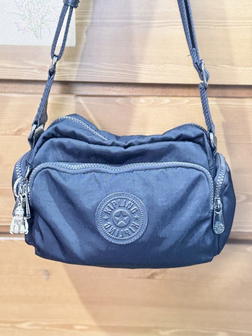 KIPLING JENERA (Category: Cross-body Bags) located in Rizal. Submitted by emskititay (Listing ID 1459035238, Image 2). Description: - Brand: Kipling - Color: Black - Material: Durable Nylon - Style: Crossbody Bag - Features: Multiple zippered compartments for organization - Strap: Adjustable shoulder strap for comfortable wear - Includes: Signature Kipling monkey charm - Ideal for: Everyday use and travel.