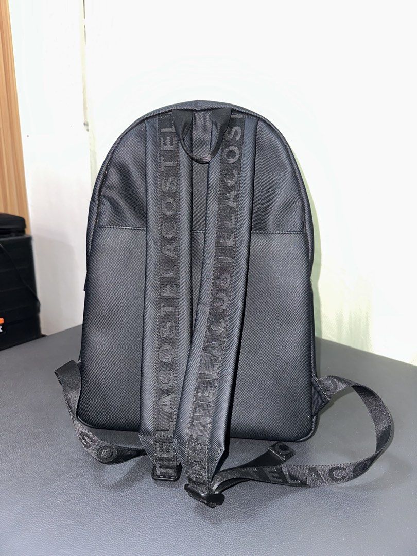 Lacoste Men's Concept Animation Backpack NH2221OA Black (Category: Backpacks) located in Manila. Submitted by shenshen_21 (Listing ID 1458907787, Image 3). Description: - Authentic Black Lacoste backpack - Iconic Lacoste logo on front pocket and straps - Spacious main compartment - Convenient front zip pocket - Practical side zip pocket - Durable material for long-lasting use - Ideal for everyday errands or travel adventures.