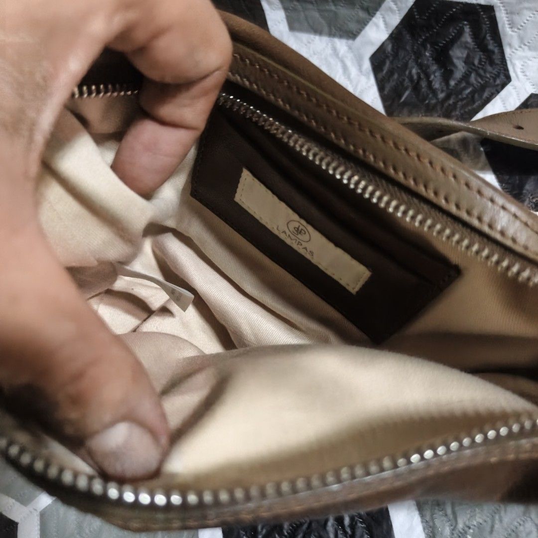 LAMPAS Brown Leather Shoulder Bag (Category: Shoulder Bags) located in Manila. Submitted by narju1234 (Listing ID 1459018616, Image 3). Description: - Brand: LAMPAS - Material: Brown Leather - Style: Soft, slouchy shoulder bag - Closure: Zipper - Strap: Adjustable - Interior: Fabric lining - Condition: Signs of wear on leather, giving a vintage look - Ideal for: Everyday use.
