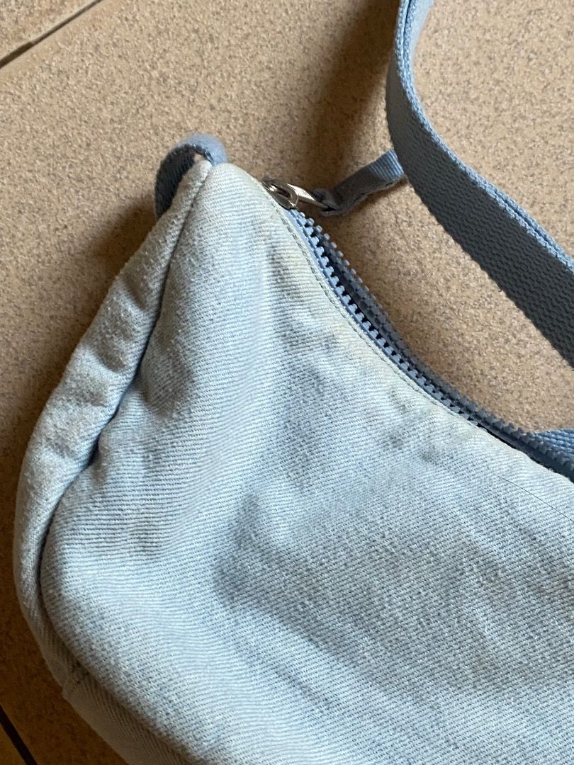 Levi's Denim Sling Bag (Category: Cross-body Bags) located in Manila. Submitted by pandi11. (Listing ID 1458965961, Image 2). Description: has yellow stains zipper area not sure how to remove, lagi sya nagkakaroon pag ginagamit sa labas - Brand: Levi's - Color: Light Blue Denim - Closure: Zipper - Strap: Adjustable - Style: Simple & Classic - Perfect for: Everyday use, carrying essentials.