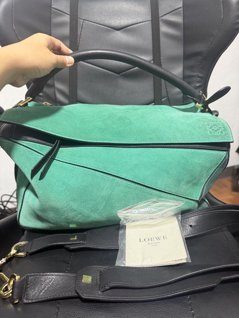 Loewe Puzzle Bag Green Suede Leather (Category: Luxury Bags & Wallets) located in Antipolo. Submitted by declutteringirlie0317 (Listing ID 1459012938, Image 1). Description: - Loewe bag in green suede and black leather - Features iconic Loewe anagram hardware - Includes a detachable shoulder strap - Interior is clean - A stylish and versatile addition to your collection -Large size perfect for travels -minimal discoloration in gold hardware due t