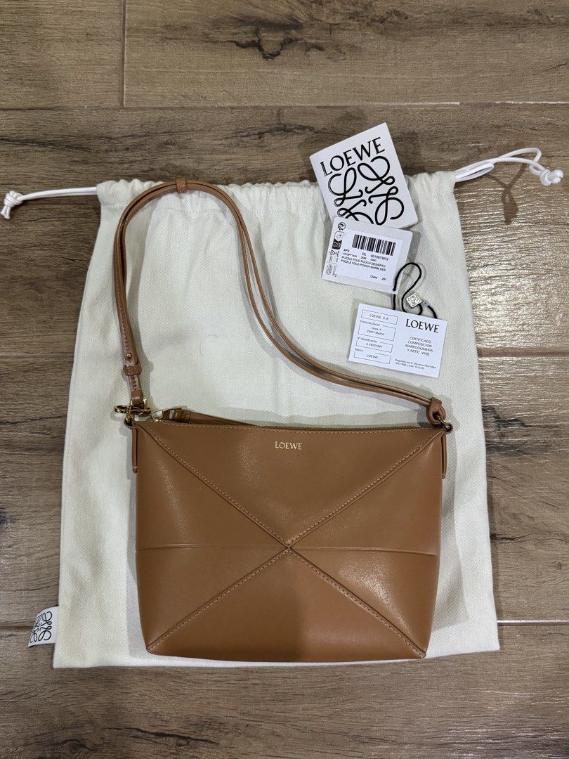 Loewe Puzzle Fold Pouch (Category: Luxury Bags & Wallets) located in Quezon City. Submitted by eyabanana08 (Listing ID 1458965769, Image 1). Description: - Authentic Loewe Puzzle Edge crossbody bag - Color: Warm Desert - Size: Small - Calfskin Shiny Nappa - Includes: Dust bag and authenticity cards - Good as bn.