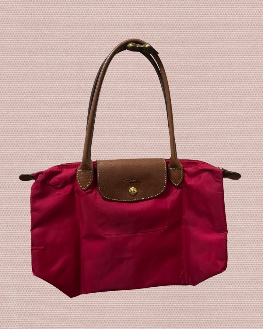 Longchamp Le Pliage Tote Bag (Small) (Category: Shoulder Bags) located in Las Pinas. Submitted by rawrmona (Listing ID 1459019697, Image 1). Description: Color: Pinkish-Red Issue: Bubbles are evident on the bag - Very loved.