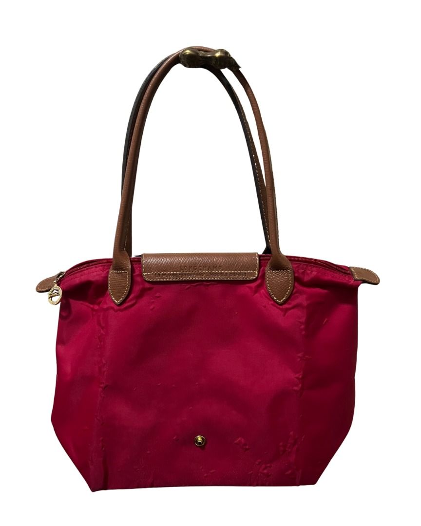 Longchamp Le Pliage Tote Bag (Small) (Category: Shoulder Bags) located in Las Pinas. Submitted by rawrmona (Listing ID 1459019697, Image 3). Description: Color: Pinkish-Red Issue: Bubbles are evident on the bag - Very loved.