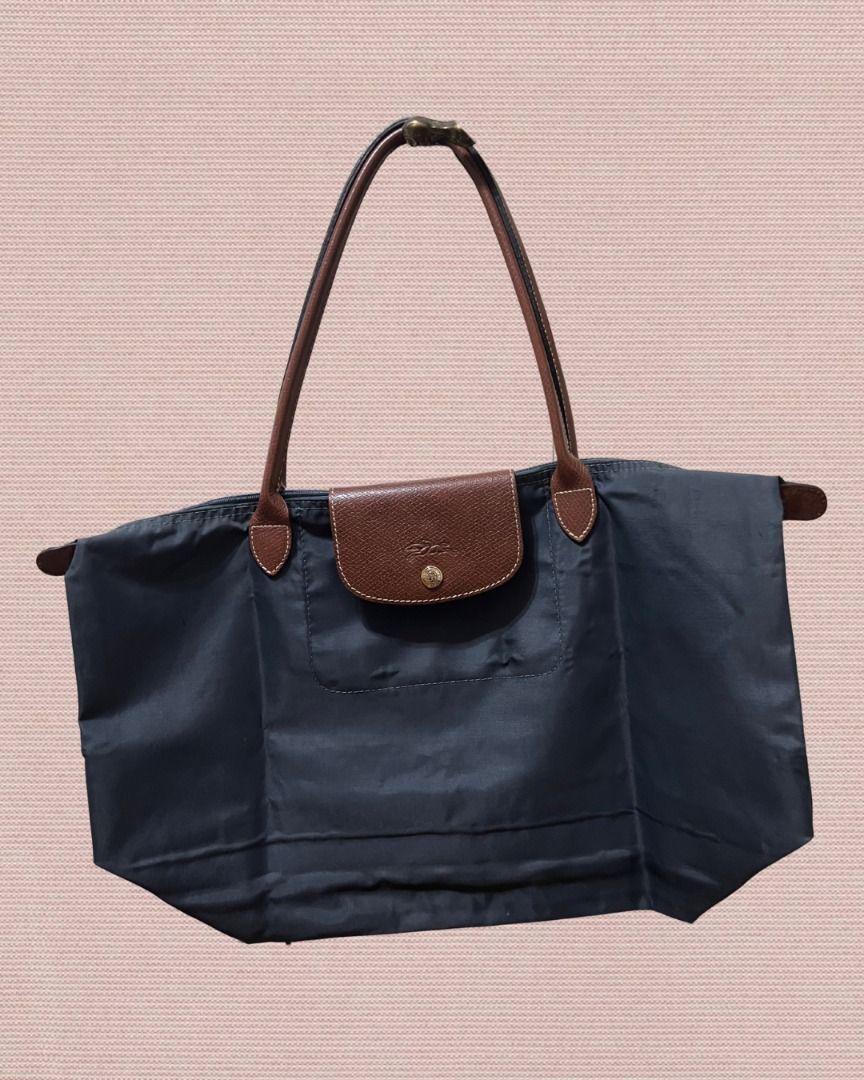 Longchamp Le Pliage Tote Bag (Large) (Category: Shoulder Bags) located in Las Pinas. Submitted by rawrmona (Listing ID 1459020017, Image 1). Description: Color: Navy/Greyish Blue Issue: Bubbles are evident on the bag - Very loved.