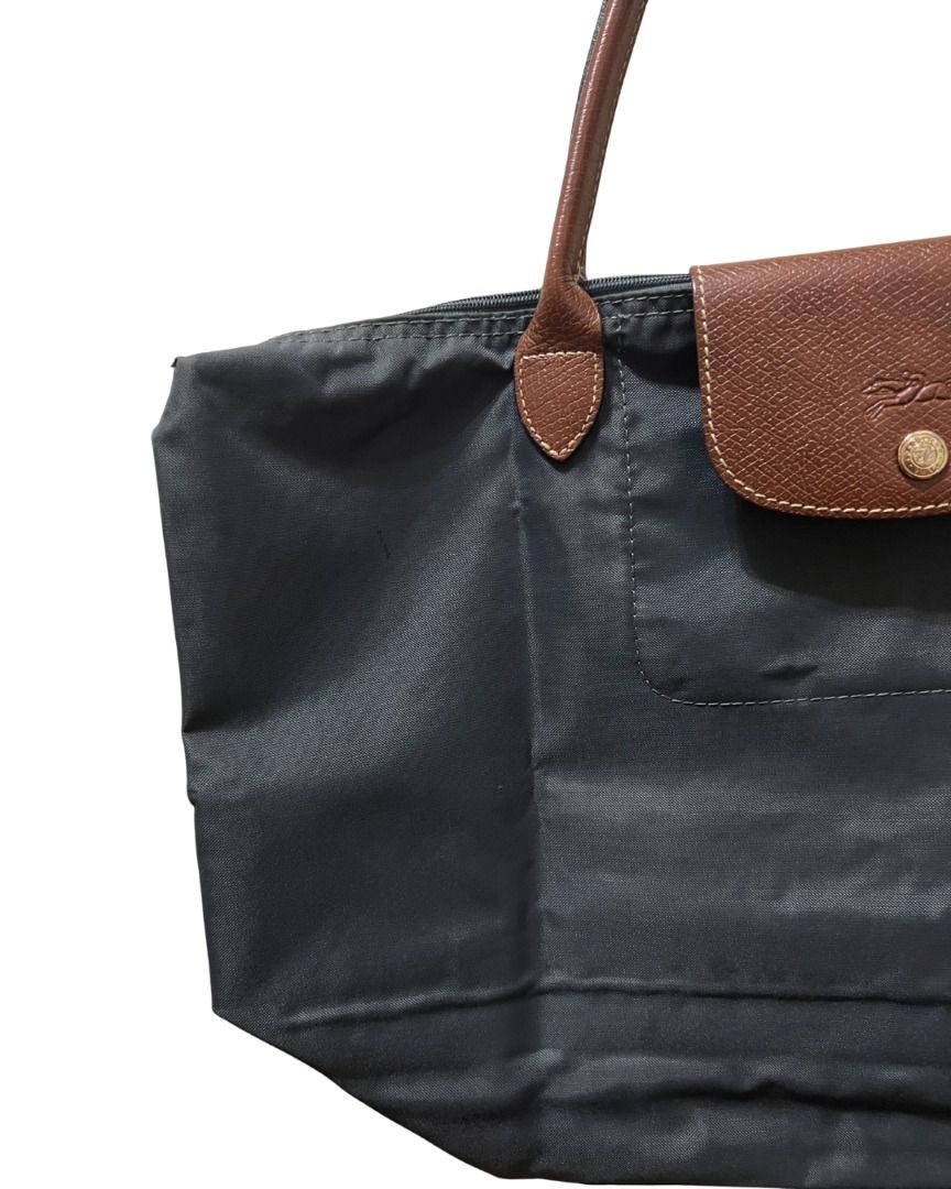 Longchamp Le Pliage Tote Bag (Large) (Category: Shoulder Bags) located in Las Pinas. Submitted by rawrmona (Listing ID 1459020017, Image 2). Description: Color: Navy/Greyish Blue Issue: Bubbles are evident on the bag - Very loved.
