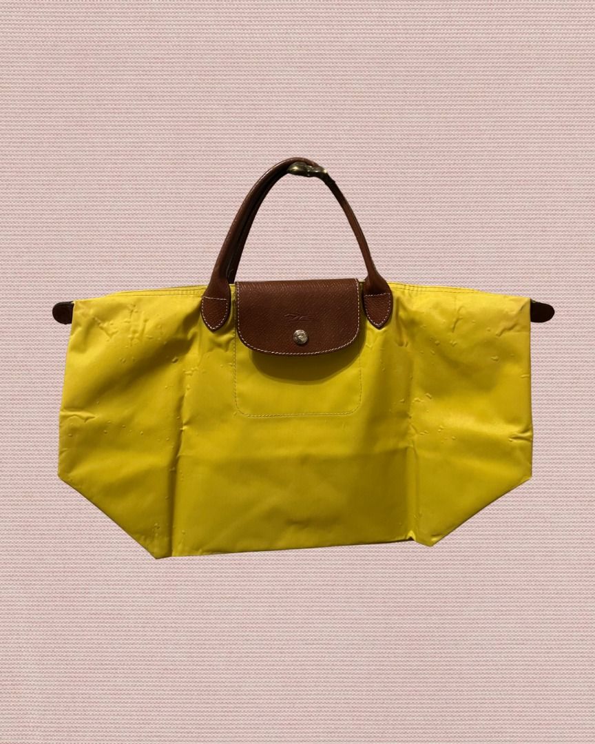 Longchamp Le Pliage Tote Bag (Medium) (Category: Tote Bags) located in Las Pinas. Submitted by rawrmona (Listing ID 1459018507, Image 1). Description: Color: Mustard Yellow Issue: Bubbles are evident on the bag - Very loved.