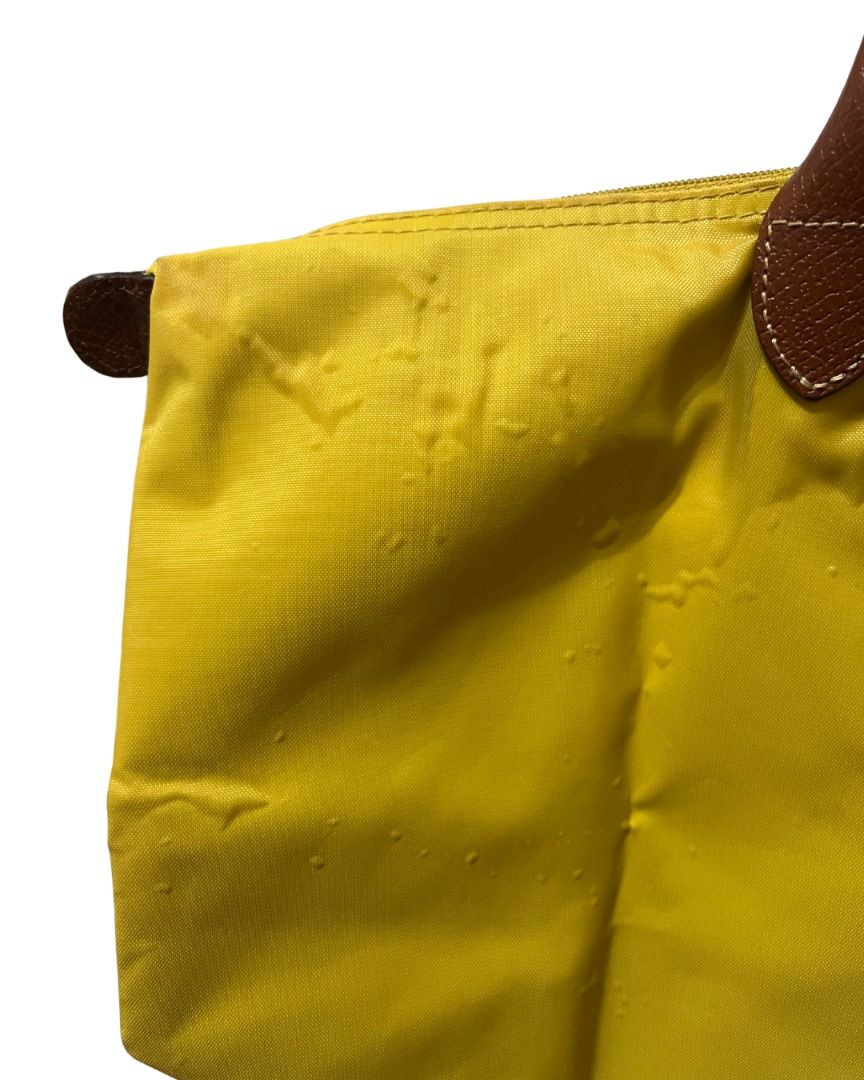 Longchamp Le Pliage Tote Bag (Medium) (Category: Tote Bags) located in Las Pinas. Submitted by rawrmona (Listing ID 1459018507, Image 2). Description: Color: Mustard Yellow Issue: Bubbles are evident on the bag - Very loved.