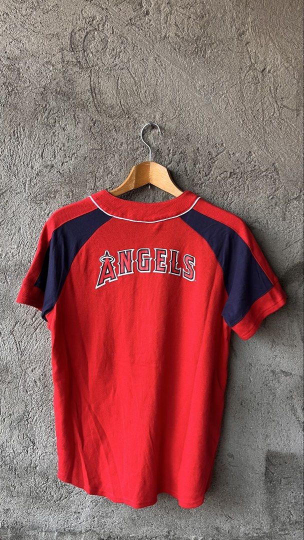 Los Angeles Angels MLB Baseball Jersey (Category: Tshirts & Polo Shirts ) located in Cabuyao City. Submitted by bulandos (Listing ID 1459012789, Image 2). Description: - Red Los Angeles Angels baseball jersey - Angels logo on front, 'ANGELS' on back - Navy blue sleeve accents and collar piping - Made by Team Athletics - Size: X-Large (18/20) - Perfect for any Angels fan!.