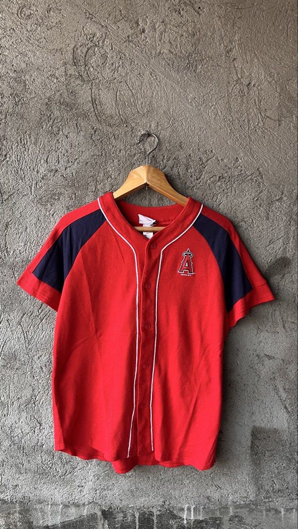 Los Angeles Angels MLB Baseball Jersey (Category: Tshirts & Polo Shirts ) located in Cabuyao City. Submitted by bulandos (Listing ID 1459012789, Image 1). Description: - Red Los Angeles Angels baseball jersey - Angels logo on front, 'ANGELS' on back - Navy blue sleeve accents and collar piping - Made by Team Athletics - Size: X-Large (18/20) - Perfect for any Angels fan!.