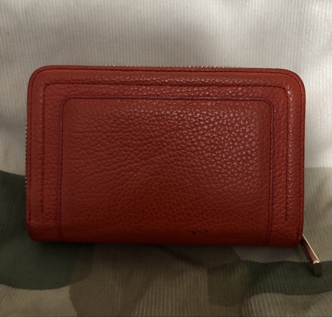 Louis Quatorze Red Leather Zip Around Wallet (Category: Wallets & Card holders) located in Naga. Submitted by taurusg (Listing ID 1458894233, Image 2). Description: - Authentic Louis Quatorze orange red leather wallet - Secure zip-around closure - Multiple card slots and clear ID window - Convenient coin pocket with snap closure - Minor marks on the exterior back - Zippers are in smooth working condition - Medium size -ykk zip .