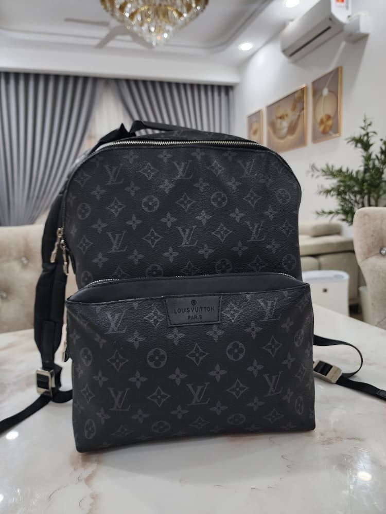Louis Vuitton Monogram Eclipse Backpack (Category: Bags & Wallets) located in Seri Kembangan. Submitted by adeliash1443745 (Listing ID 1459024291, Image 1). Description: - Louis Vuitton backpack - Monogram Eclipse canvas - Front zip pocket - Interior: Main compartment + smaller pocket - Made in France.
