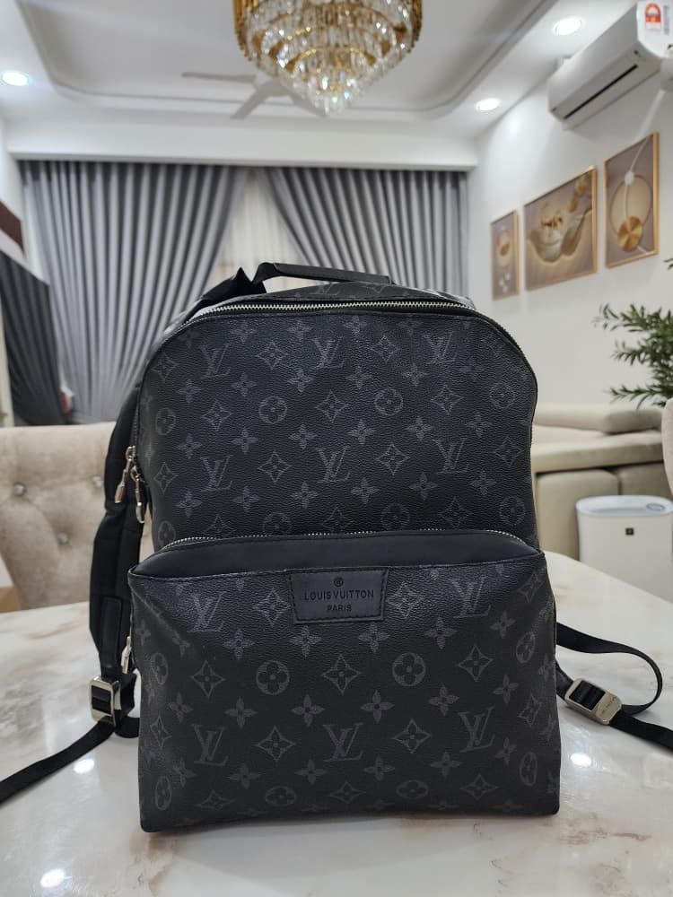 Louis Vuitton Monogram Eclipse Backpack (Category: Bags & Wallets) located in Seri Kembangan. Submitted by adeliash1443745 (Listing ID 1459024291, Image 3). Description: - Louis Vuitton backpack - Monogram Eclipse canvas - Front zip pocket - Interior: Main compartment + smaller pocket - Made in France.