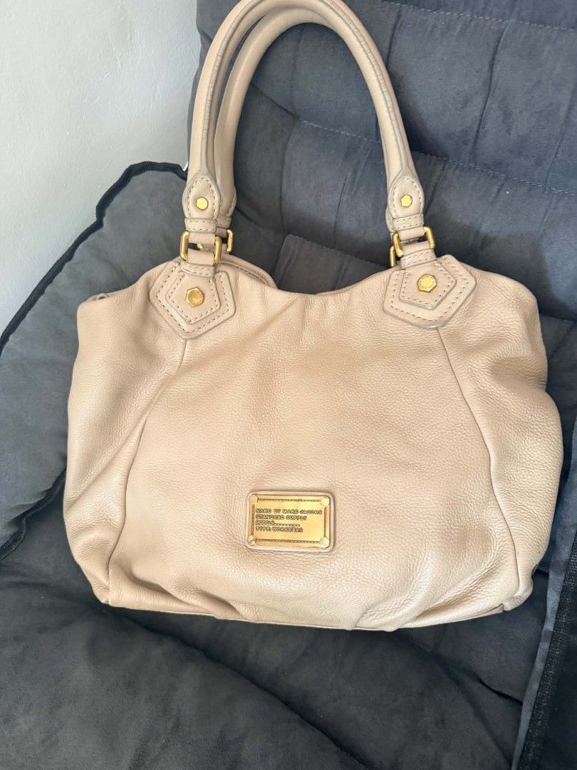 Marc by Marc Jacobs Standard Supply Leather Handbag (Category: Luxury Bags & Wallets) located in Pinamalayan. Submitted by chay0921 (Listing ID 1458969003, Image 1). Description: - Brand: Marc by Marc Jacobs - Style: Standard Supply Handbag - Material: Soft Leather - Color: Tan/Beige - Condition: Good overall, with visible wear on handles (as pictured) - Features: Spacious interior, classic design - Perfect for: Everyday use.