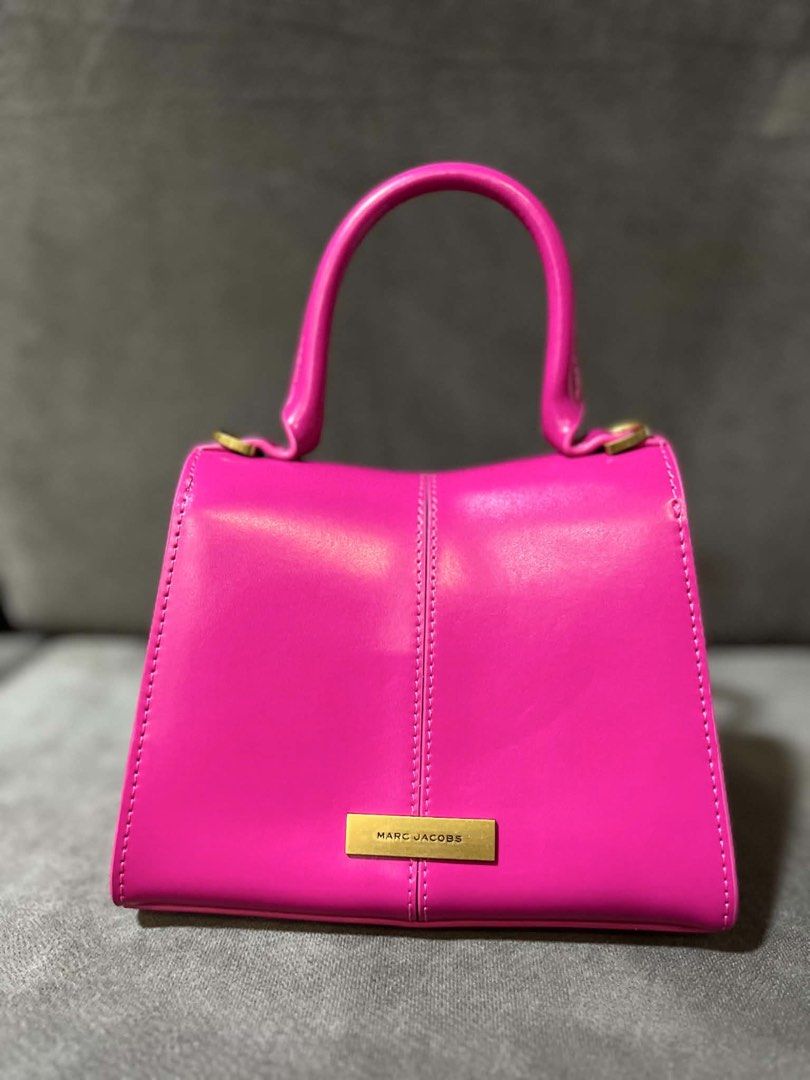 Marc Jacobs Pink Top Handle Bag with Gold Chain (Category: Luxury Bags & Wallets) located in Lipa City. Submitted by thyra06 (Listing ID 1458895106, Image 3). Description: - Vibrant bright pink Marc Jacobs handbag - Chic gold chain detail on the front flap - Includes a detachable gold chain strap for versatile wear - Interior features convenient card slots - Adds a perfect pop of color to any outfit - Please check photos for detailed condition.