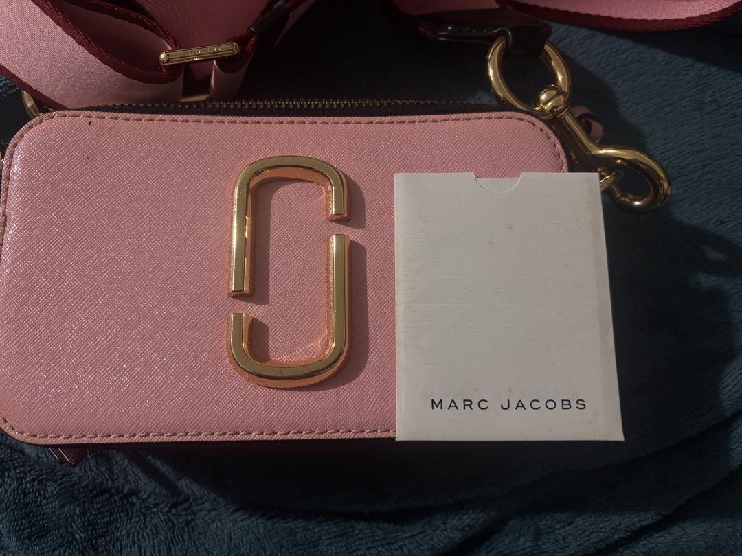 Marc Jacobs Snapshot Camera Bag Pink Gold (Category: Luxury Bags & Wallets) located in Manila. Submitted by fleurdebelle (Listing ID 1459058804, Image 2). Description: - Authentic Pink Marc Jacobs Snapshot bag - Features signature gold hardware - Comes with the original adjustable strap - Includes authenticity cards for peace of mind - Convenient back pocket for quick access Price is negotiable. MOP: Gcash/Gotyme.