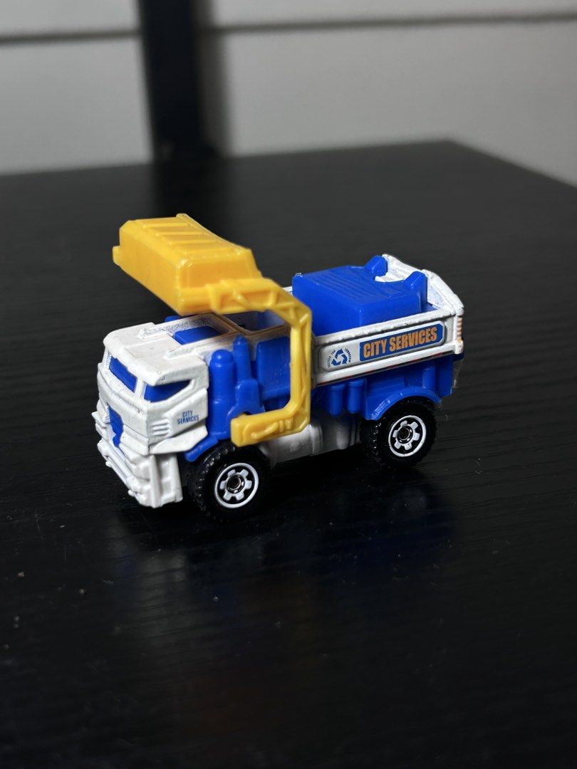 Matchbox City Services Garbage Truck Toy (Category: Vehicle & Diecast Models) located in San Marcelino. Submitted by sainthustle (Listing ID 1459059449, Image 2). Description: - Matchbox garbage truck - Blue and white with yellow front loader - Marked 'City Services' - Made in Thailand - Ideal for imaginative play.