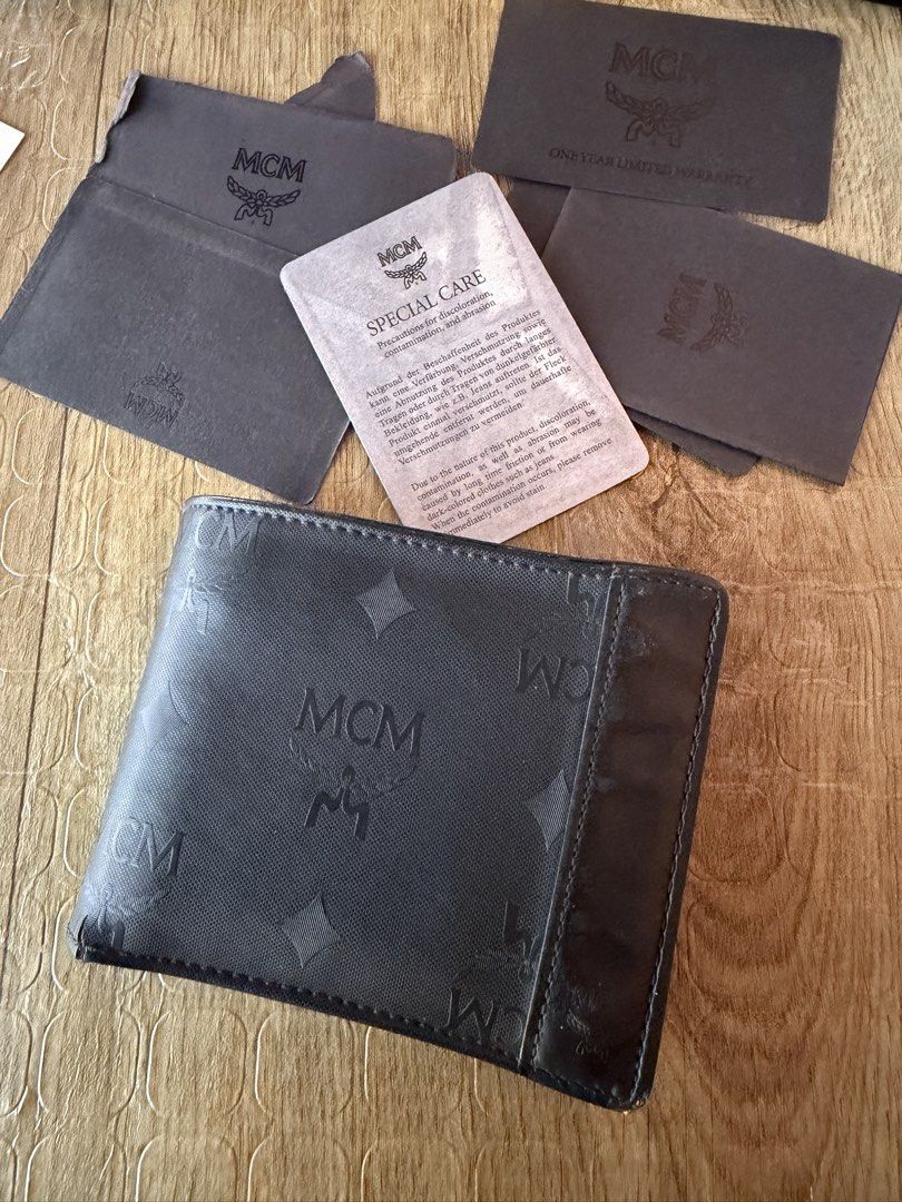 MCM Bifold Wallet with Monogram Pattern (Category: Luxury Bags & Wallets) located in Manila. Submitted by raven236 (Listing ID 1458947226, Image 2). Description: - Authentic MCM bifold wallet - Features all-over MCM monogram pattern - Multiple interior card slots - Clear ID window - Includes original dust bag - Comes with special care card - Includes warranty card - Ideal for everyday use.