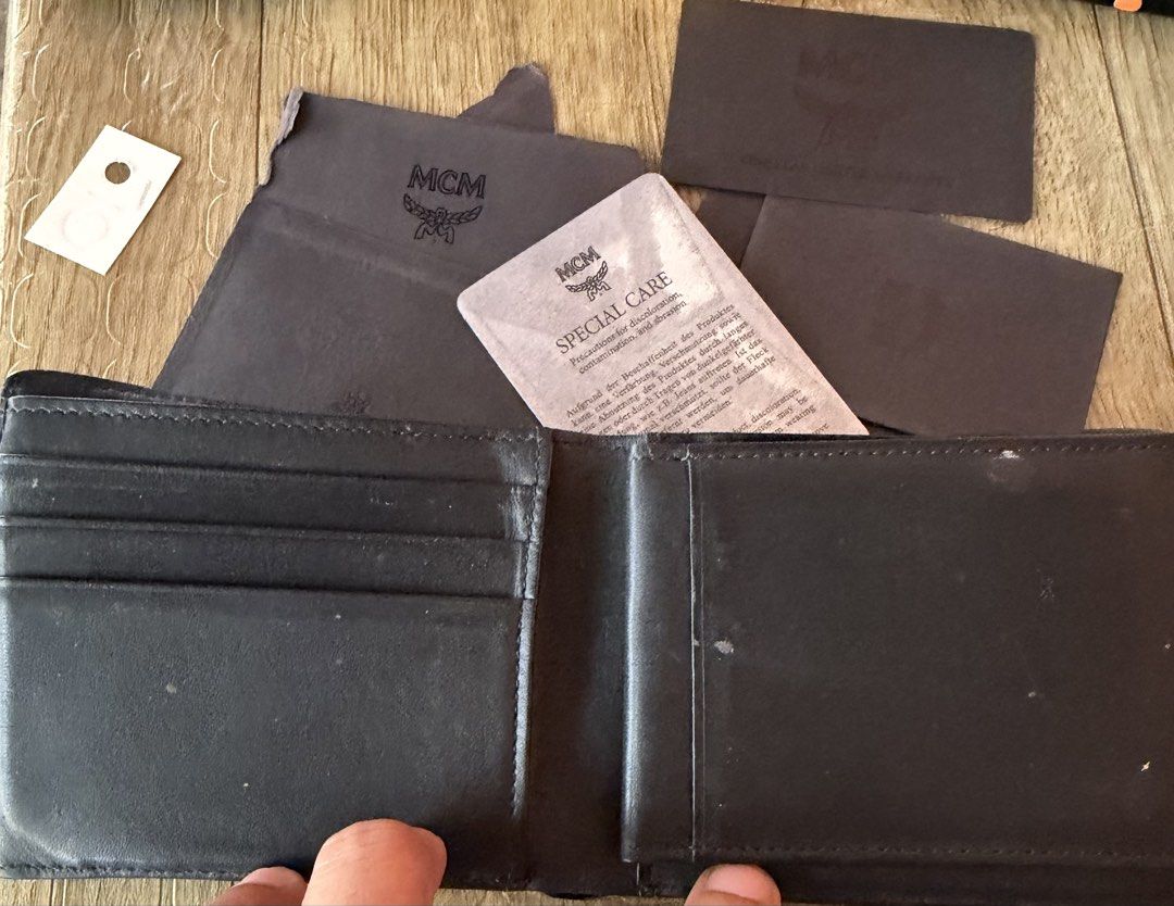 MCM Bifold Wallet with Monogram Pattern (Category: Luxury Bags & Wallets) located in Manila. Submitted by raven236 (Listing ID 1458947226, Image 3). Description: - Authentic MCM bifold wallet - Features all-over MCM monogram pattern - Multiple interior card slots - Clear ID window - Includes original dust bag - Comes with special care card - Includes warranty card - Ideal for everyday use.