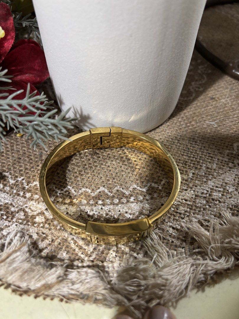 Michael Kors Gold Tone Hinged Bangle Bracelet (Category: Bracelets) located in San Mateo. Submitted by ariakid47 (Listing ID 1458968476, Image 3). Description: - Gold tone Michael Kors hinged bangle - Engraved with 'Michael Kors Est. 1981' - Classic and chic design - Features a convenient hinged clasp for easy wear - Versatile for everyday or dressing up - A timeless accessory.