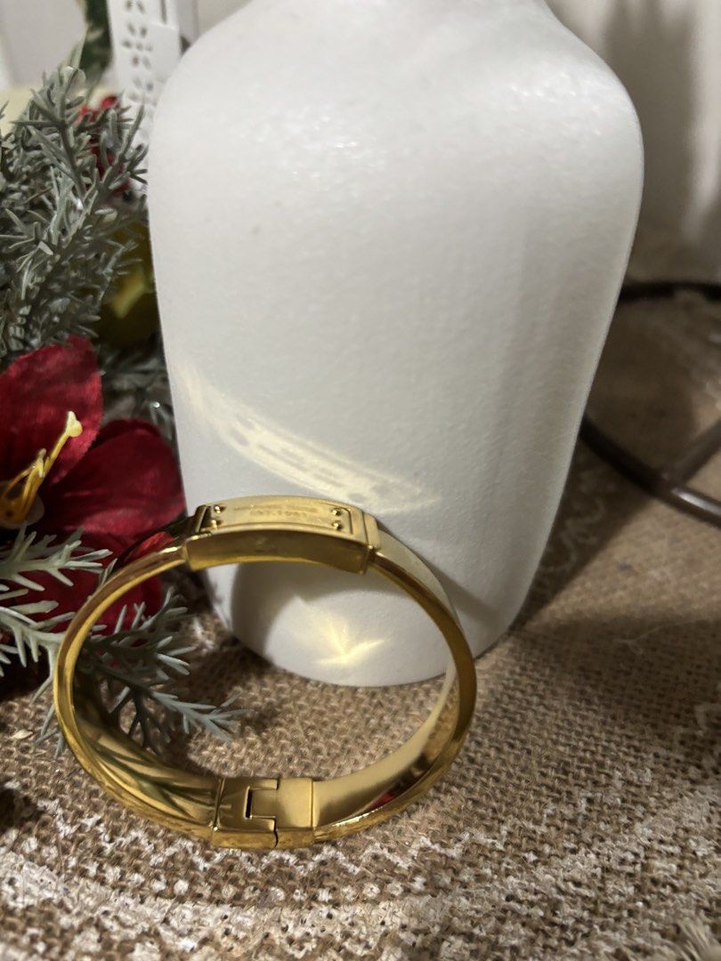 Michael Kors Gold Tone Hinged Bangle Bracelet (Category: Bracelets) located in San Mateo. Submitted by ariakid47 (Listing ID 1458968476, Image 2). Description: - Gold tone Michael Kors hinged bangle - Engraved with 'Michael Kors Est. 1981' - Classic and chic design - Features a convenient hinged clasp for easy wear - Versatile for everyday or dressing up - A timeless accessory.