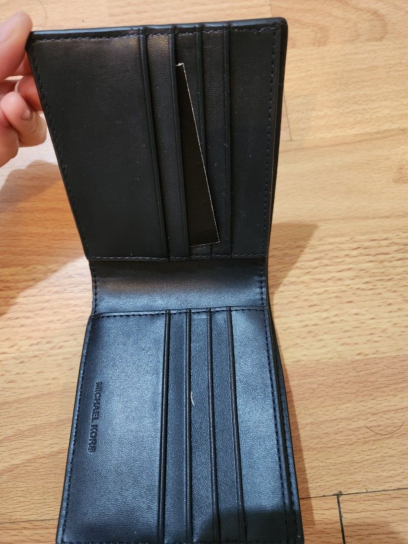 Michael Kors Harrison Navy Leather Bifold Wallet Passcase (Category: Luxury Bags & Wallets) located in Quezon City. Submitted by destashtorestash (Listing ID 1458953823, Image 2). Description: - Michael Kors Harrison Bifold Wallet - Color: Navy - Material: Textured Leather - Features: Multiple card slots, Passcase section - Condition: Comes with original tag - Benefit: Great for organizing your essentials.