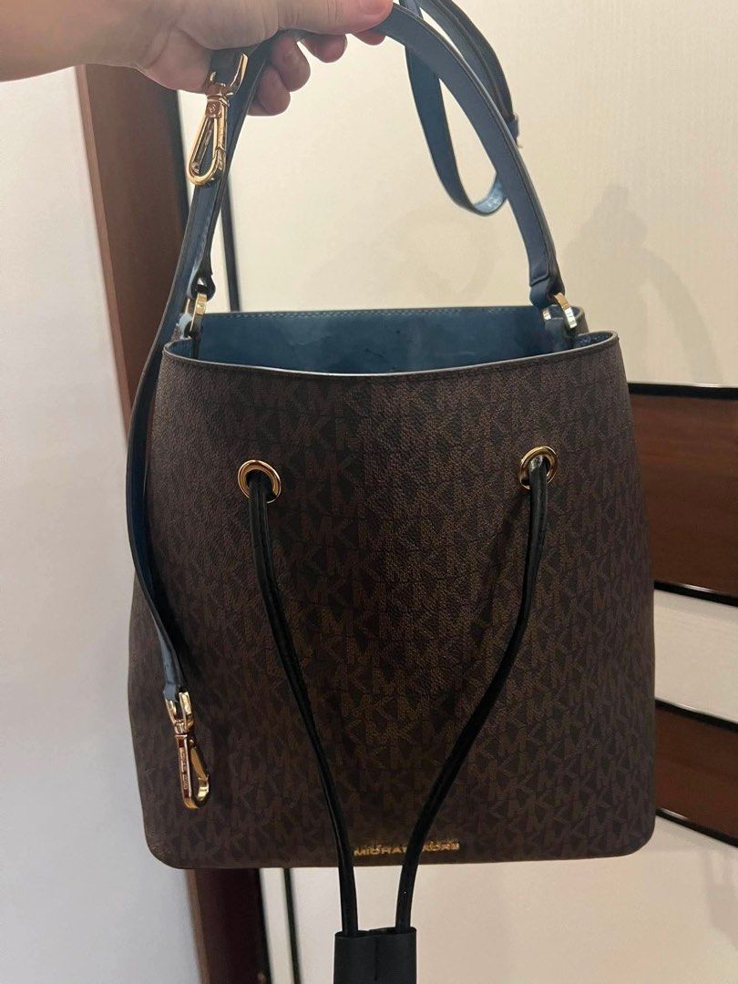 Michael Kors Monogram Bucket Bag (Category: Luxury Bags & Wallets) located in Quezon City. Submitted by anna_rl23 (Listing ID 1459088237, Image 1). Description: - Authentic Michael Kors bucket bag - Signature monogram print in brown - Contrasting blue interior - Secure drawstring closure - Adjustable strap for comfortable wear - Gold hardware details - Please note: some wear on interior lining, as pictured - Includes original dust bag.
