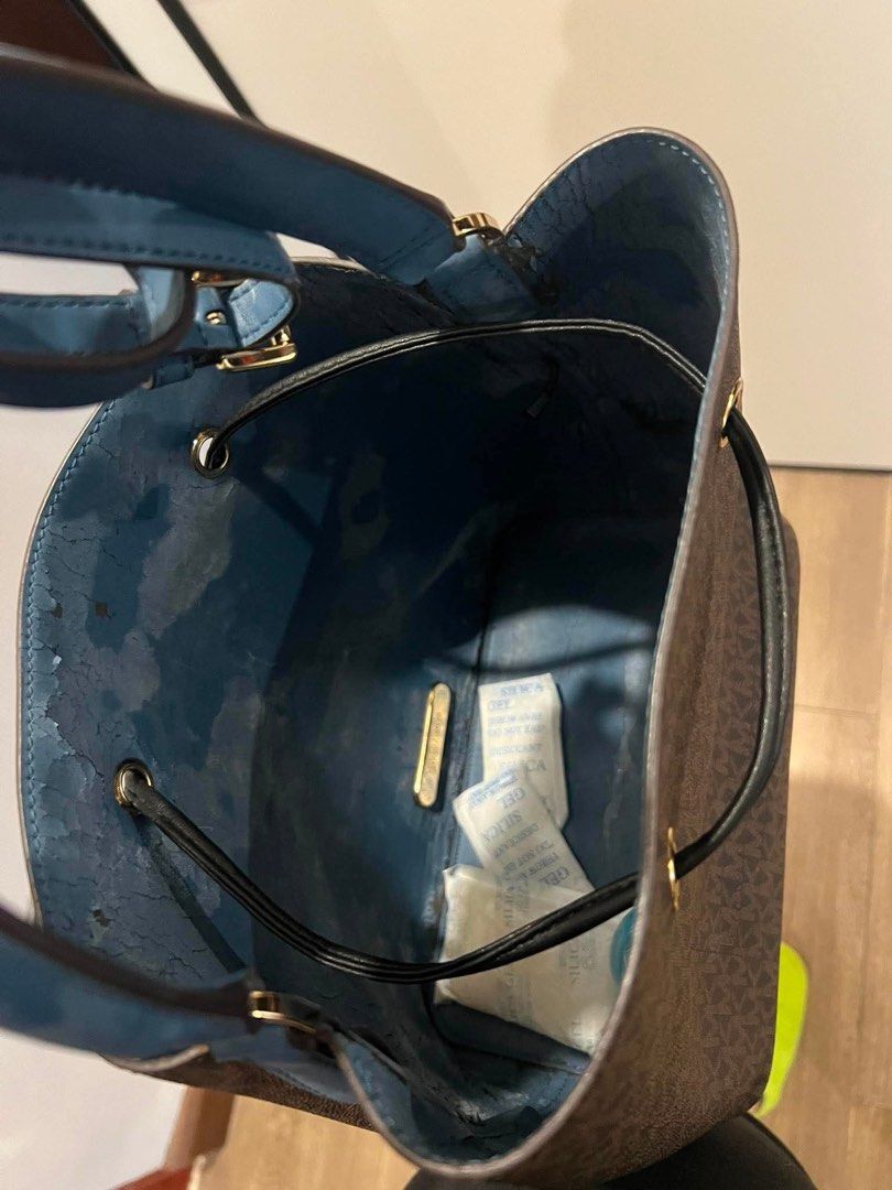 Michael Kors Monogram Bucket Bag (Category: Luxury Bags & Wallets) located in Quezon City. Submitted by anna_rl23 (Listing ID 1459088237, Image 2). Description: - Authentic Michael Kors bucket bag - Signature monogram print in brown - Contrasting blue interior - Secure drawstring closure - Adjustable strap for comfortable wear - Gold hardware details - Please note: some wear on interior lining, as pictured - Includes original dust bag.